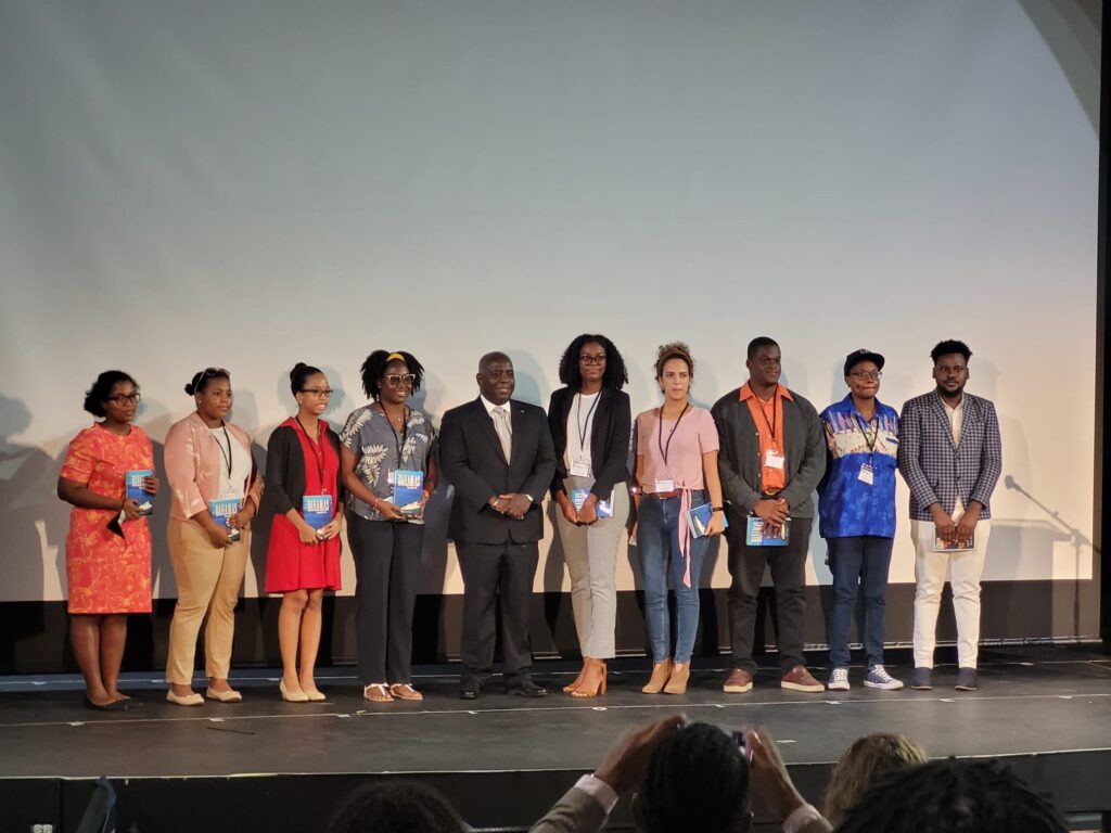 Shows a Group photo of The Prime Minister and Caribbean Youth